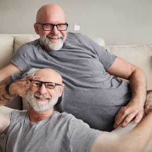 Two similar bald white men with beards, one growing out of the other