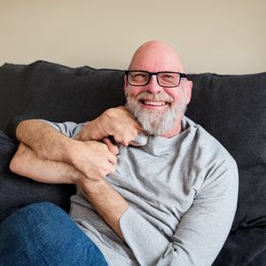 Bald white man with four arms, no dogs, and the wrong number of fingers